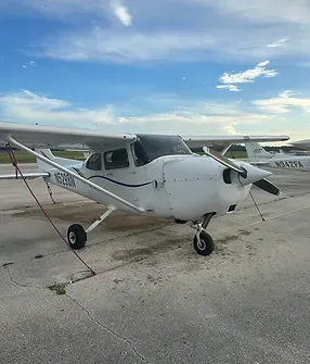 A small white plane sitting on top of an airport runway.