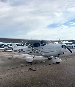 A small white plane sitting on top of an airport runway.