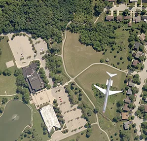 An aerial view of a plane in the middle of a park.