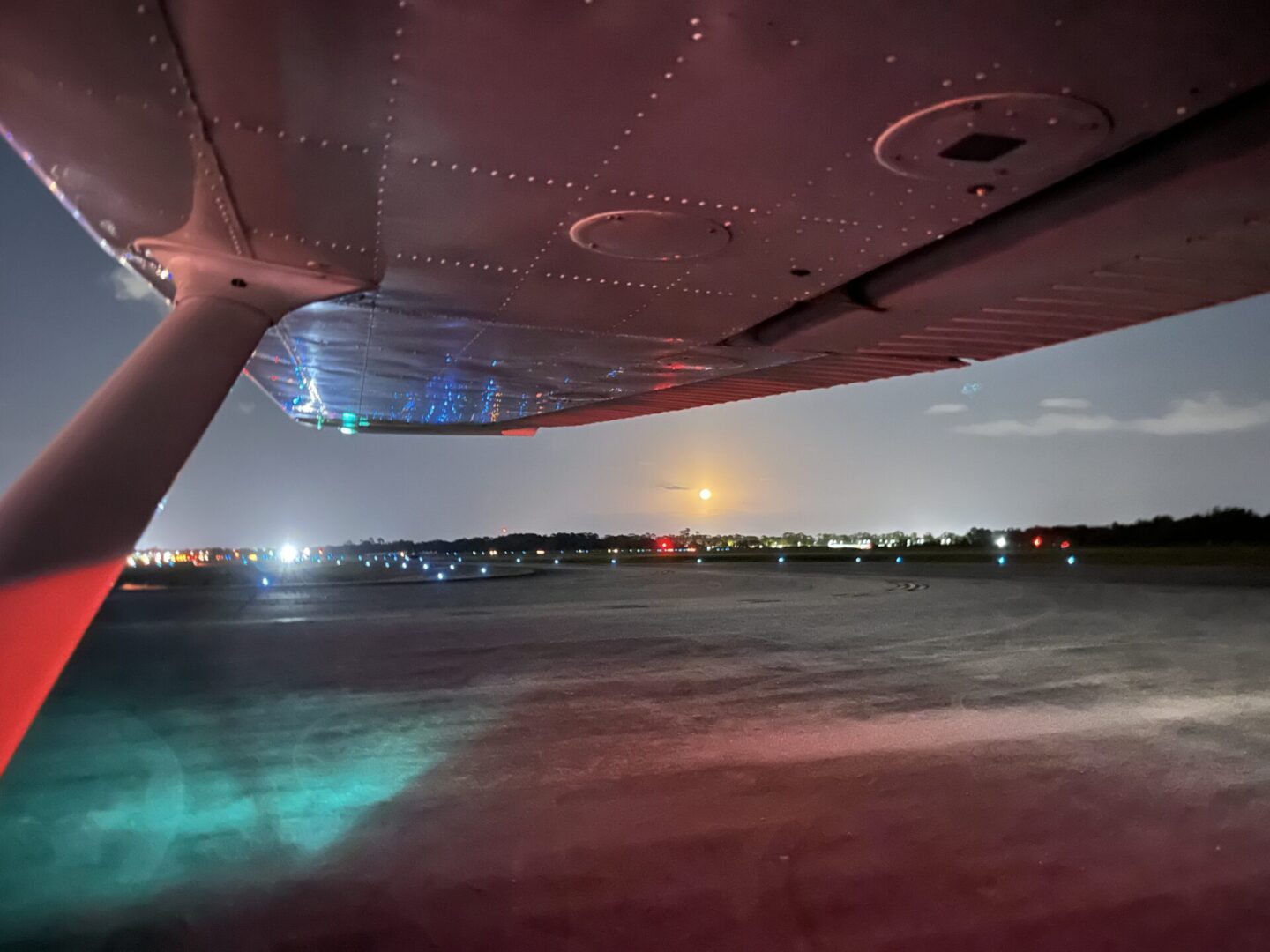 Wing of small airplane at night